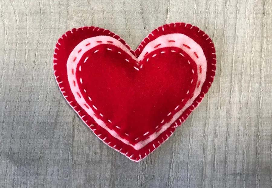 Several layers of colorful felt hearts filled with lavender inside