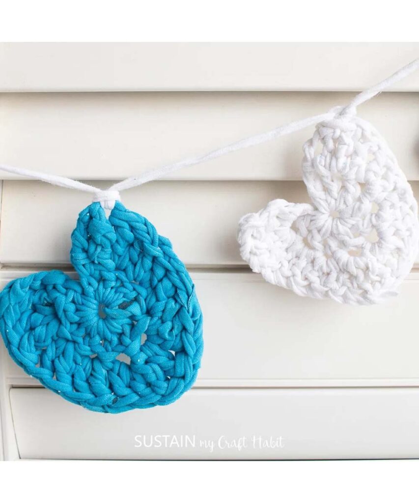 Blue and White crocheted tshirt yarn hearts hang on a garland banner