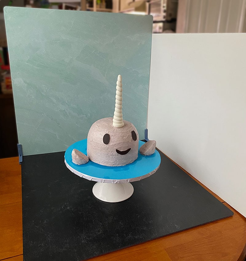 replica surfaces flanking a birthday cake