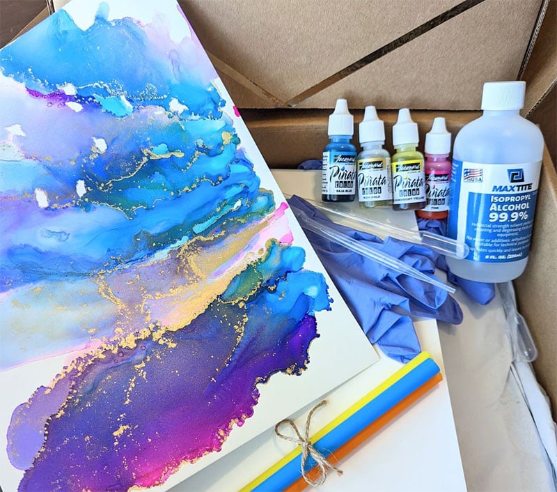 Alcohol Ink DIY Kit features artwork example and supplies all neatly wrapped in a kraft box