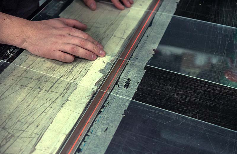 a person heats plexiglass in order to bend it