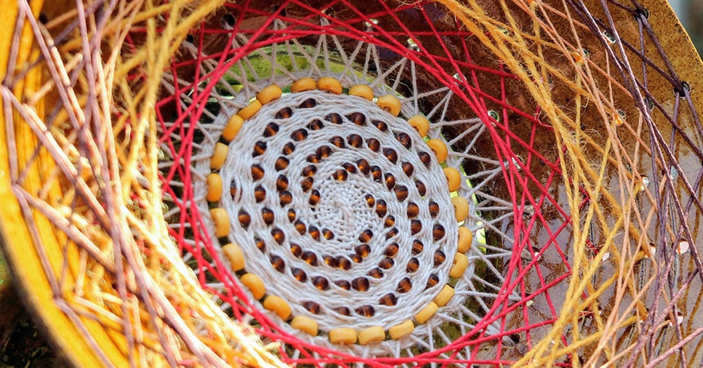 close up of woven beaded ceramic art