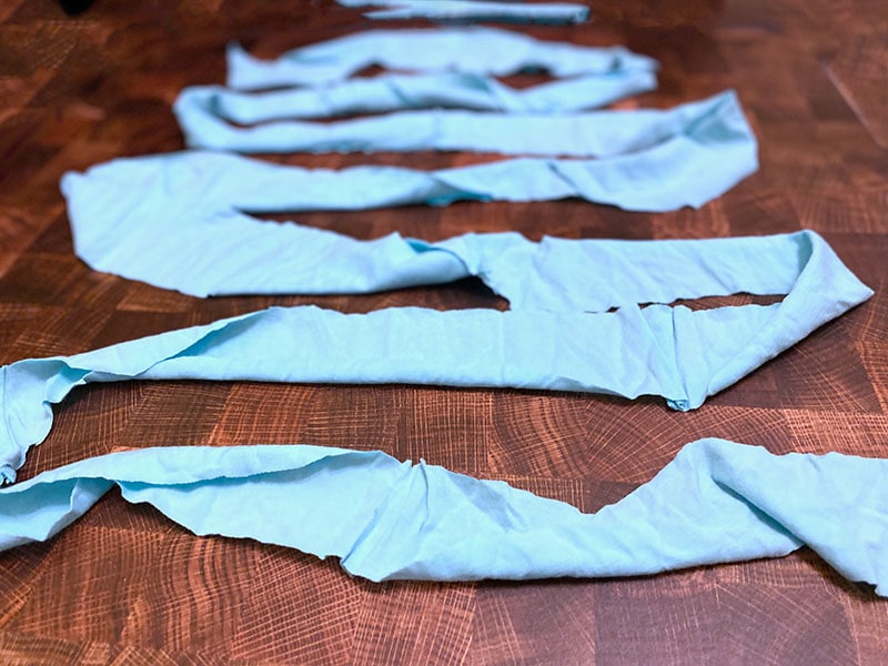 t shirt yarn is laid out in a winding pattern across a wooden surface