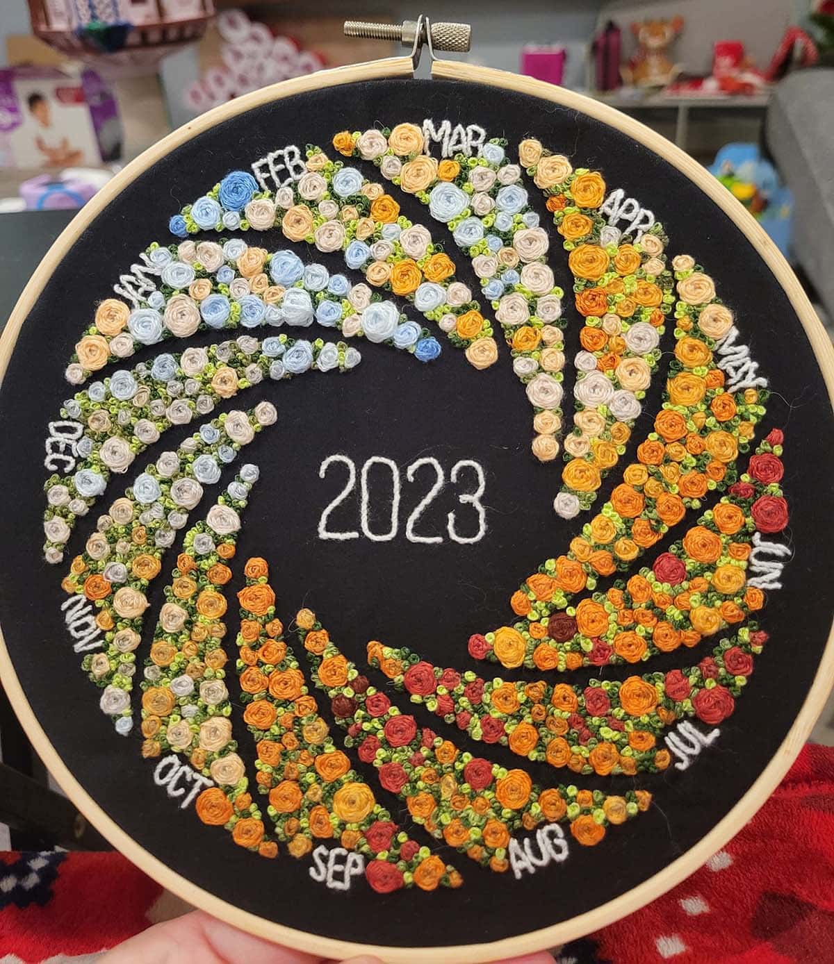 365 days represented by flower stitches all coordinated colors to the high temp of the day